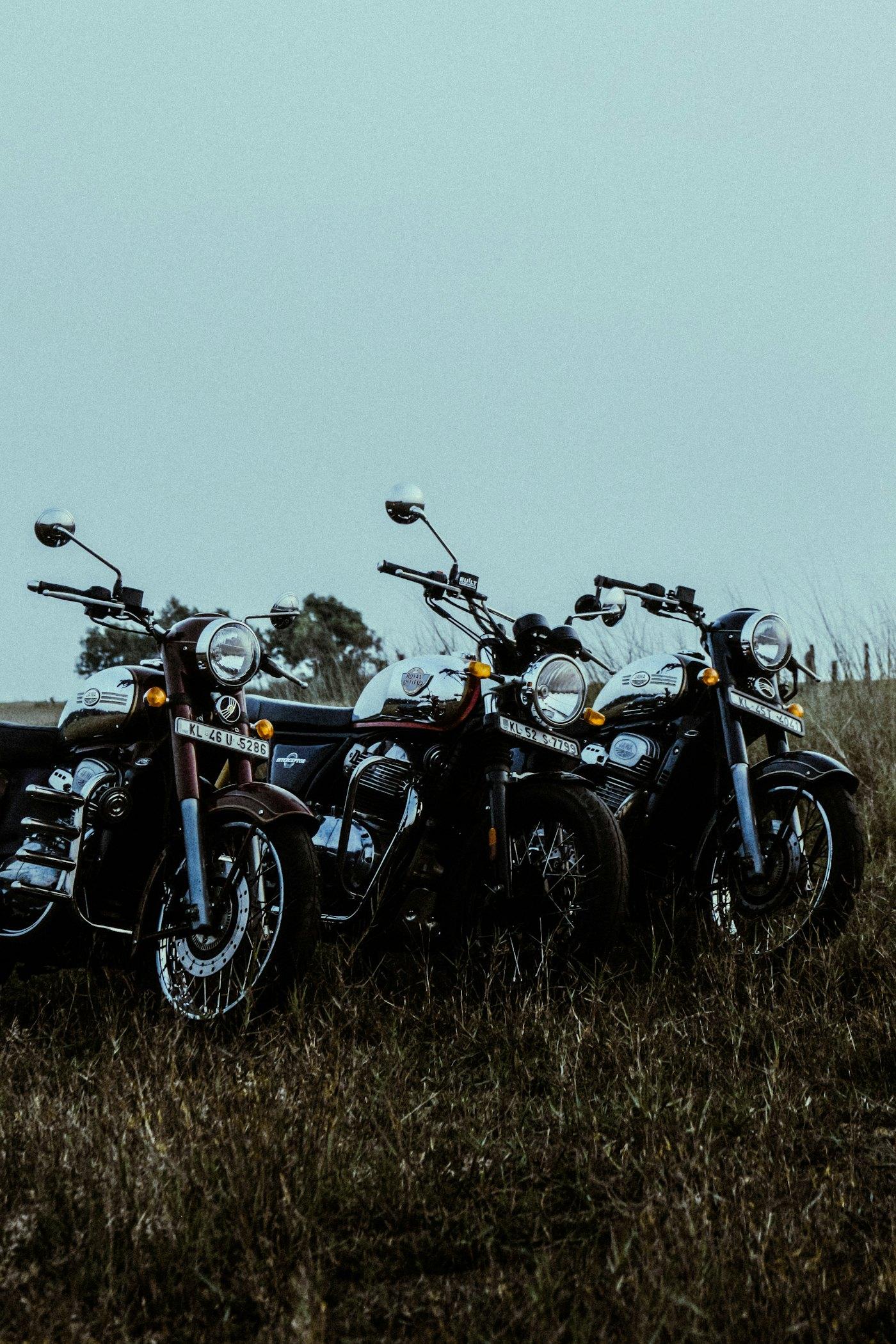 Adventure bikes parked together in a field at a rally