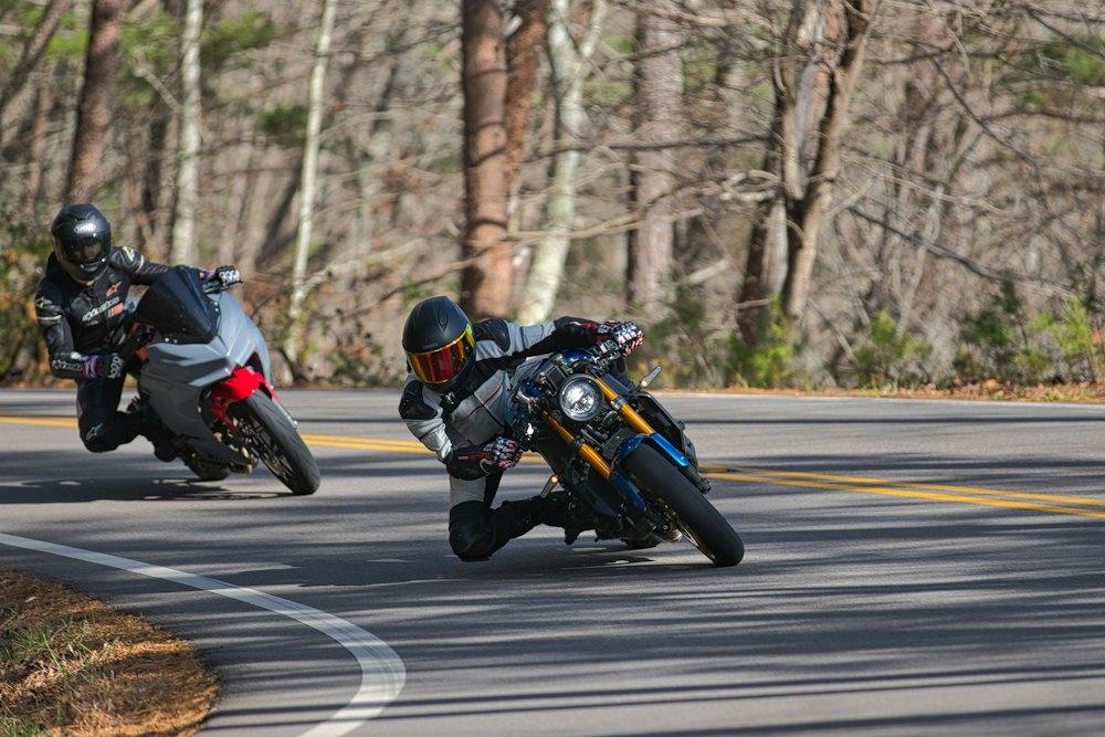 Two riders leaning into a bend