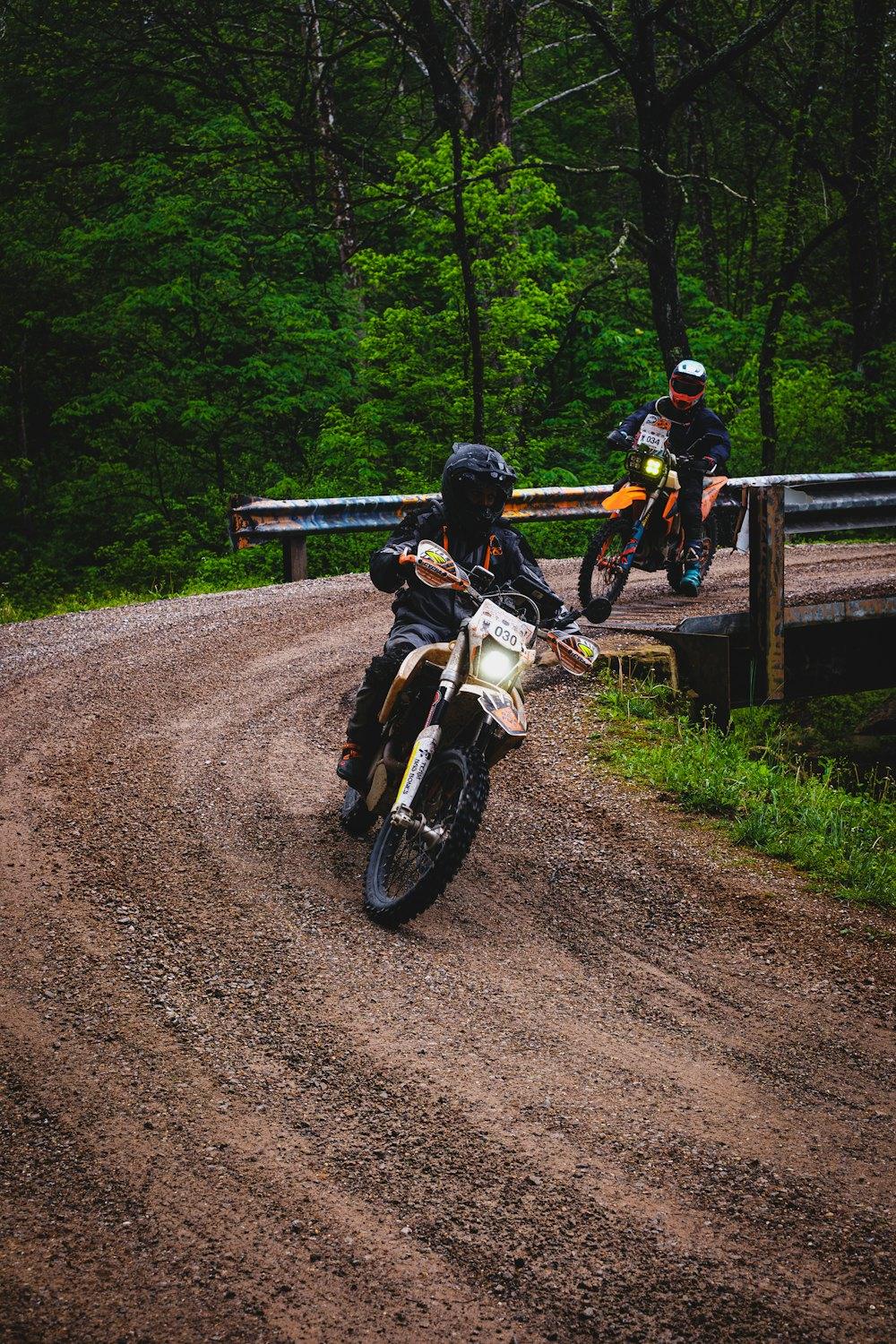 Enduro riders on a muddy forest trail